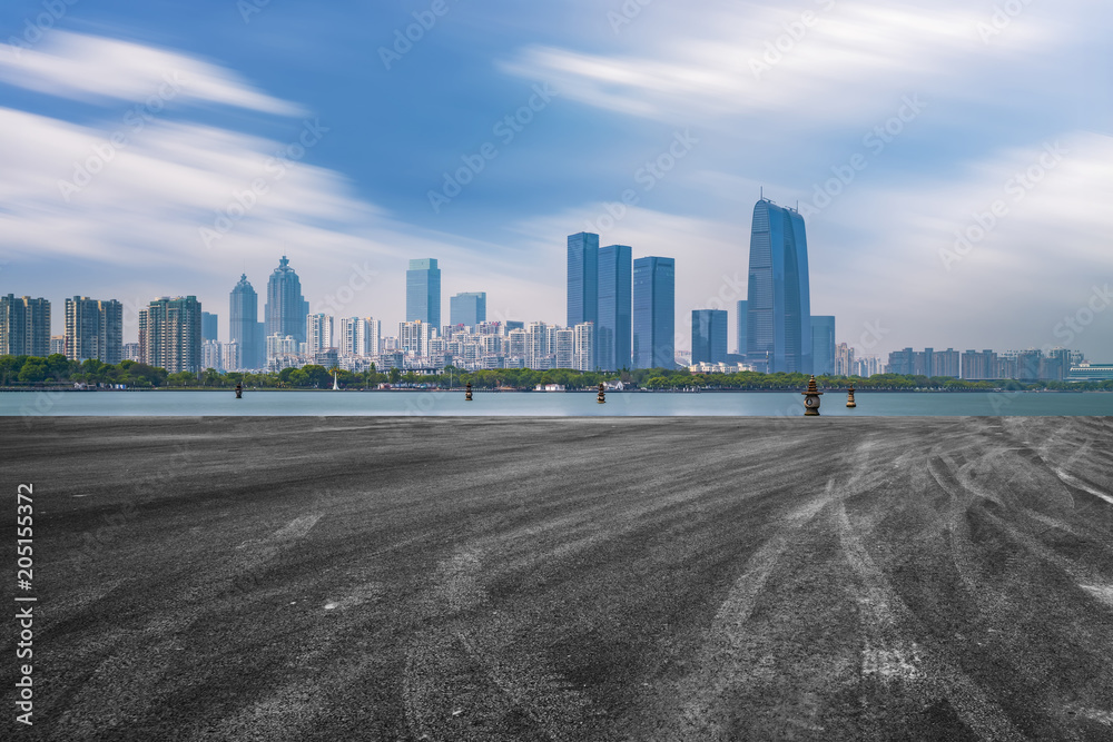 The empty asphalt road is built along modern commercial buildings in China's cities. The empty asphalt road is built along modern commercial buildings in China's cities.