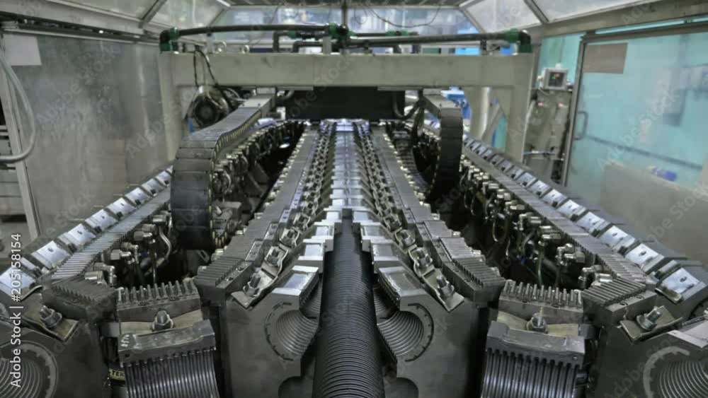 Manufacture of plastic water pipes. Manufacturing of tubes to the factory. The process of making plastic pipes on the machine tool with the use of water and air pressure. Special corrugated forms of Manufacture of plastic water pipes. Manufacturing of tubes to the factory. The process of making plastic pipes on the machine tool with the use of water and air pressure. Special corrugated forms of