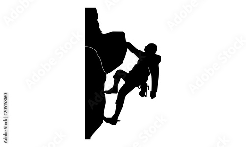 a silhouette picture of a man climbing a rock