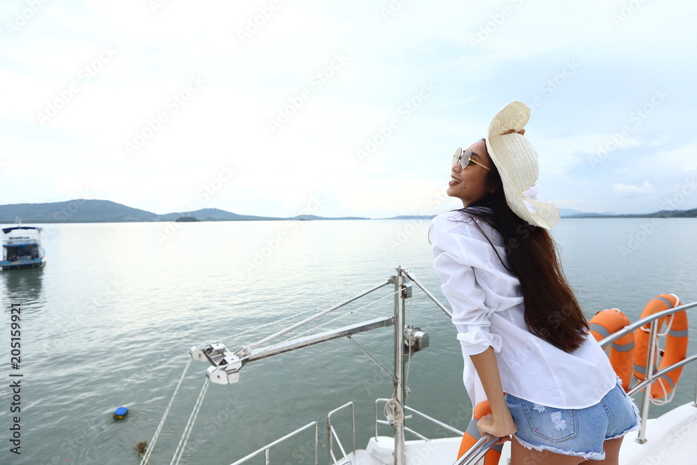 Asian Mix Race Tanned skin Woman Bikini Hat short jean stand on deck of Yacht Boat