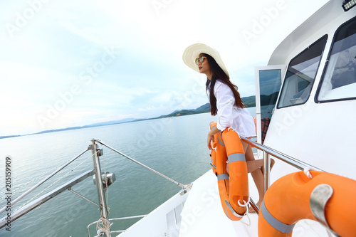 Asian Mix Race Tanned skin Woman Bikini Hat short jean stand on deck of Yacht Boat © Jade