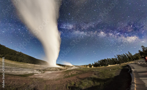 The Milky Way rising over Old Faithful erupting in Yellowstone National Park (Wyoming)