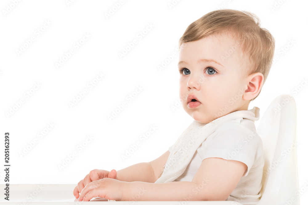 baby boy in bib sitting in highchair isolated on white background baby boy in bib sitting in highchair isolated on white background