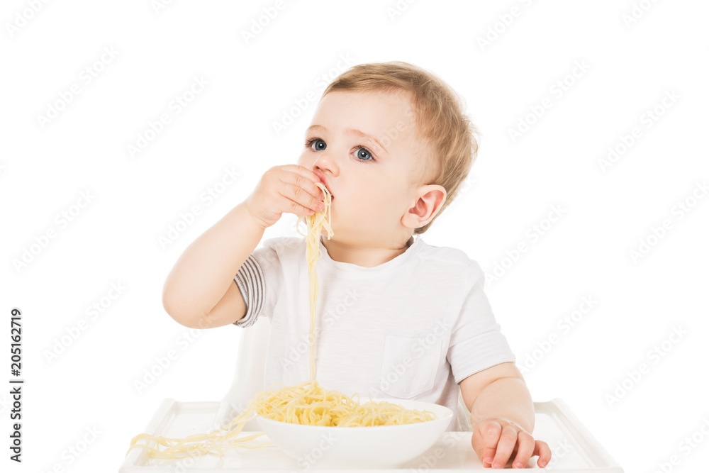 little boy in highchair eating spaghetti by hand isolated on white background little boy in highchair eating spaghetti by hand isolated on white background