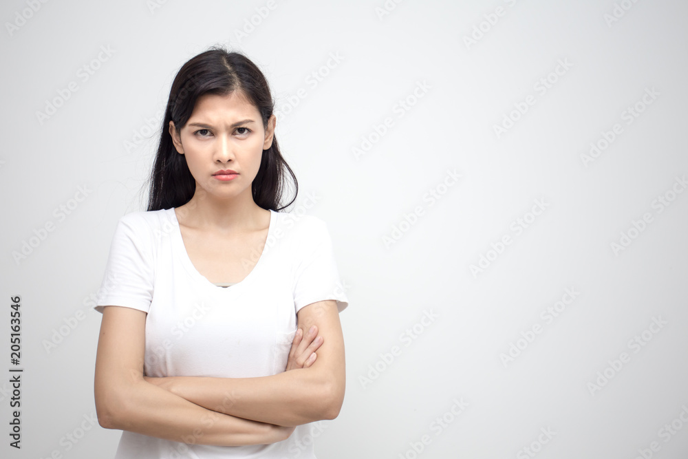 Young asian woman looking to camera with angry emotion. Isolated on white background. Young asian woman looking to camera with angry emotion. Isolated on white background.