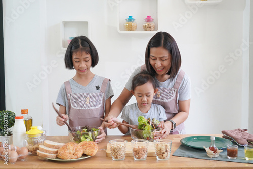 Mother and daughter cooking in the kitchen at home  happy family asian concept