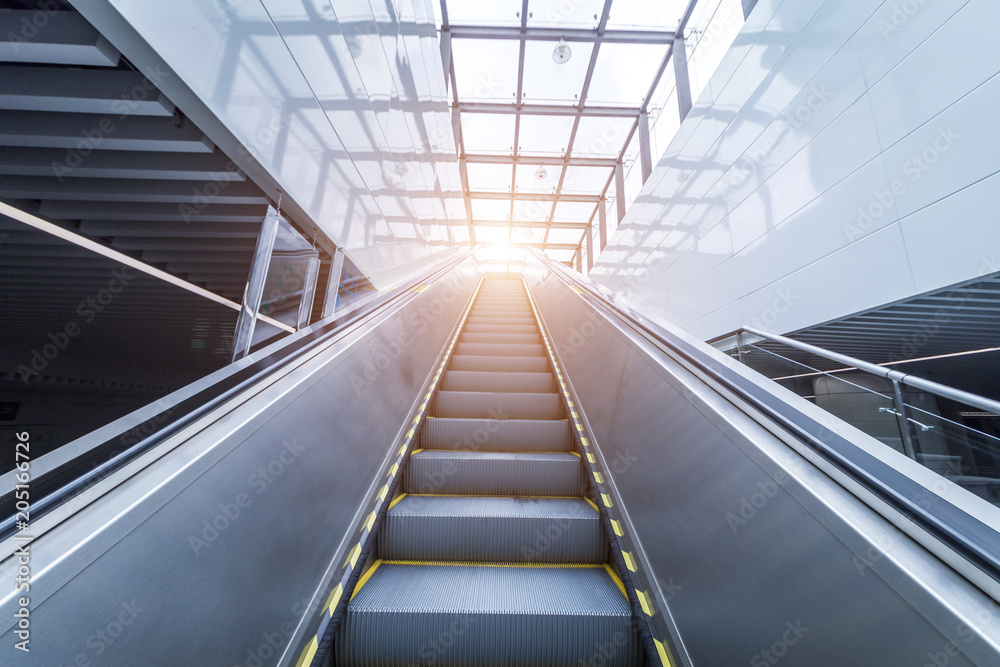 Close up to escalator yellow and gray steel line.