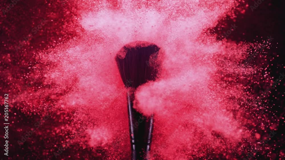 Make up brush and colored powder/particles exploding. Shot with high speed camera, phantom flex 4K. Slow Motion.