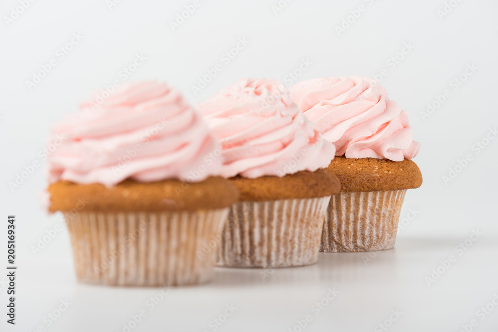 tasty cooked pink cupcakes on white