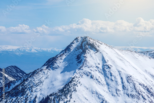 Landscape of snow-capped peaks of the rocky mountains in Sunny weather. Concept of nature and travel © Artem