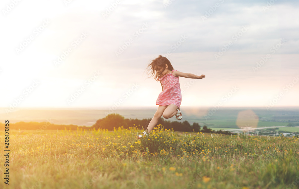 Pretty little girl jumping outdoors Pretty little girl jumping outdoors