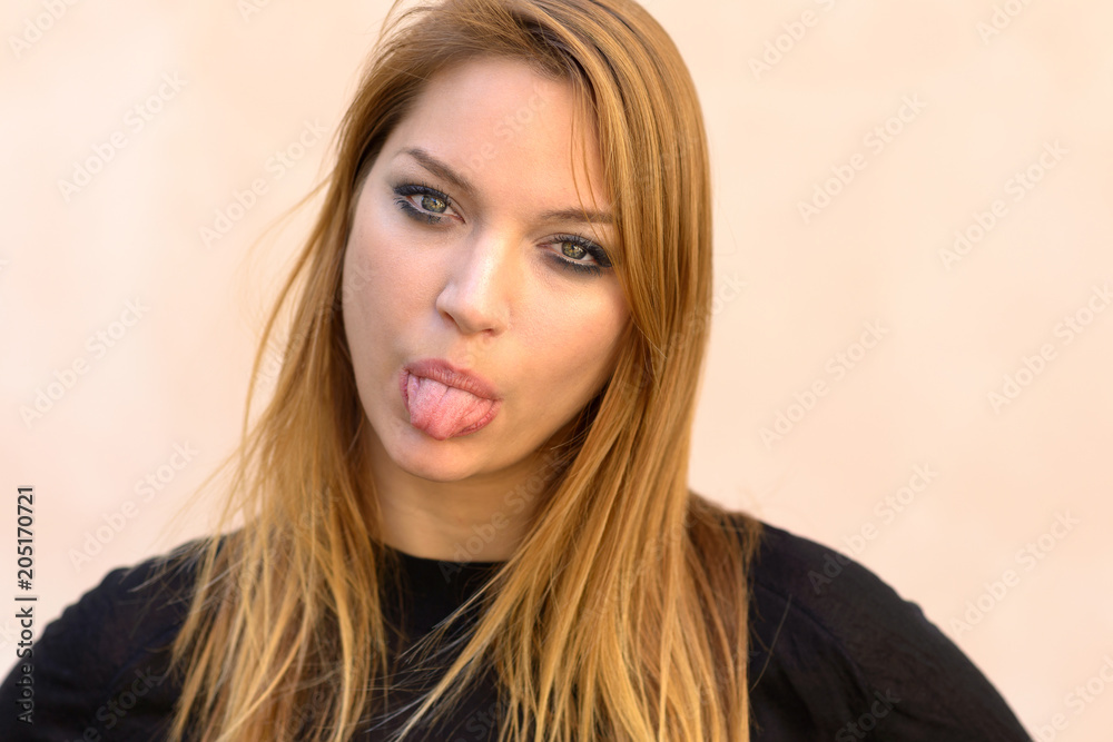 Blond woman sticking out her tongue Blond woman sticking out her tongue