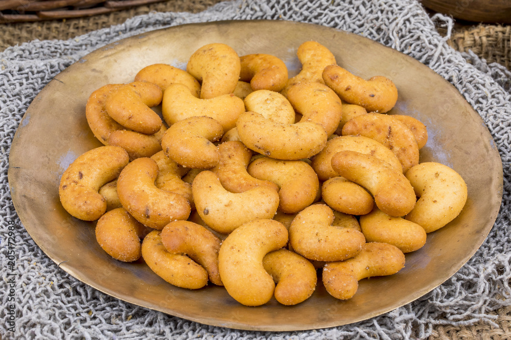 Salted Flavor Roasted Cashew Nut Snacks Served in Plate Also Know as in India Kaju Namkeen or Masala Kaju on Vintage Background