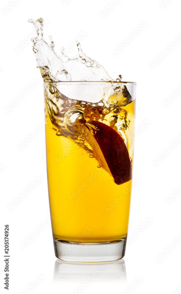 Splash from an apple slice in high glass of apple juice Splash from an apple slice in high glass of apple juice