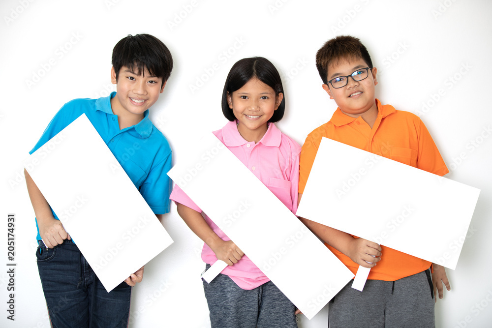 Happy smiling group of kids showing blank placard board. Happy smiling group of kids showing blank placard board.