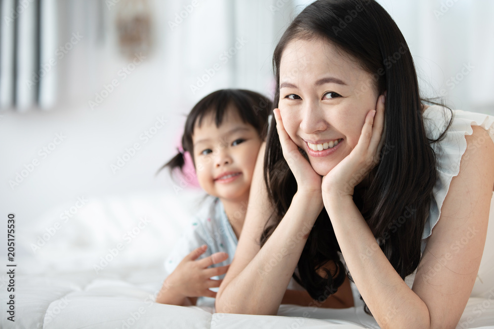 Happy asian family mother with daughter playing on bed with smile face. Happy asian family mother with daughter playing on bed with smile face.
