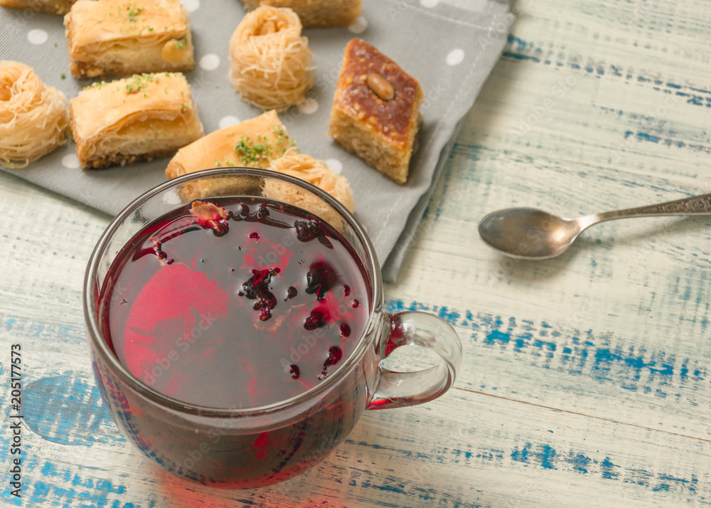 Fruit tea and oriental sweets on a wooden background. Fruit tea and oriental sweets on a wooden background.