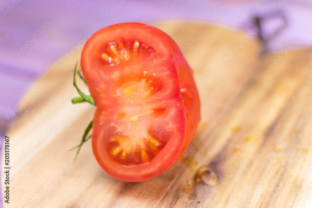 Fresh tomato on a wooden background.