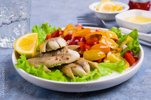 Fish fillet with raw vegetables photo