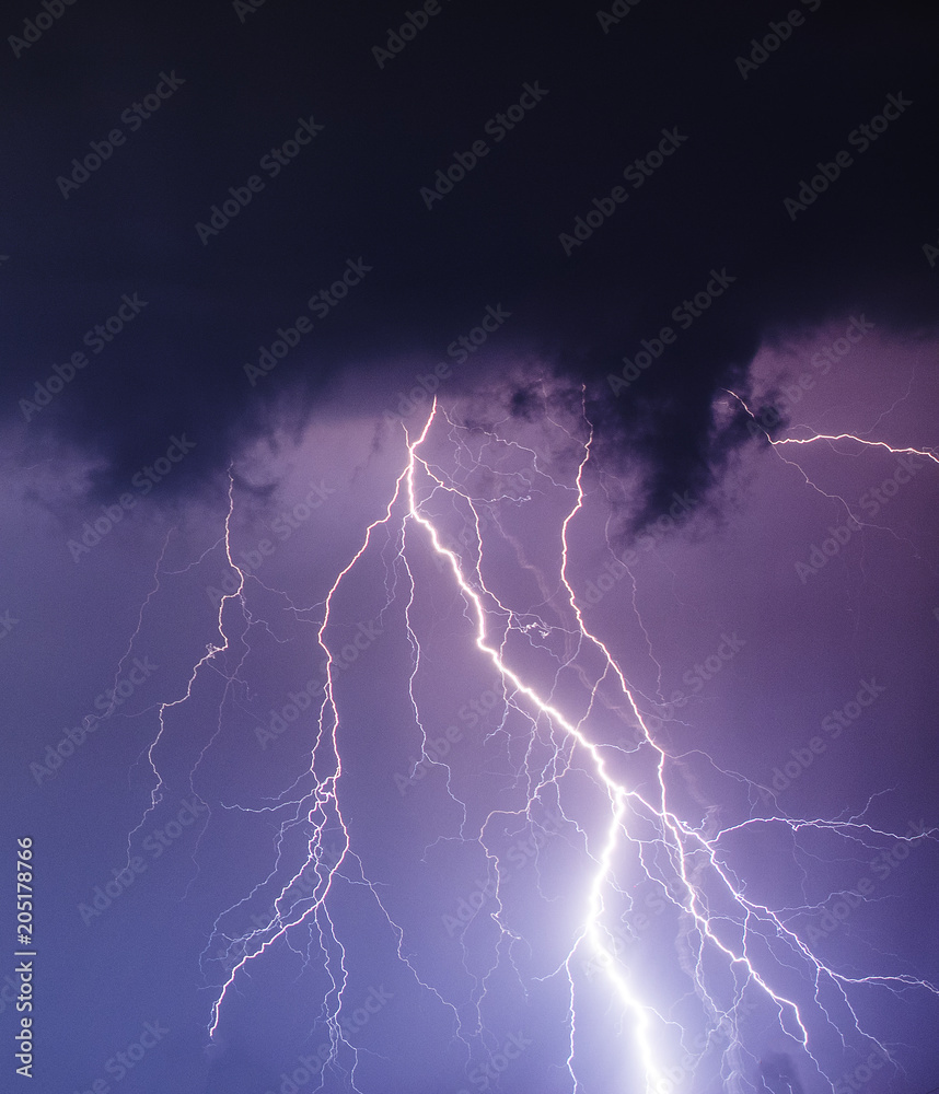 powerful lightning strikes over night sky