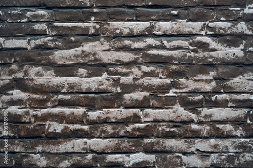 background of bricks under a thin layer of painted faded putty