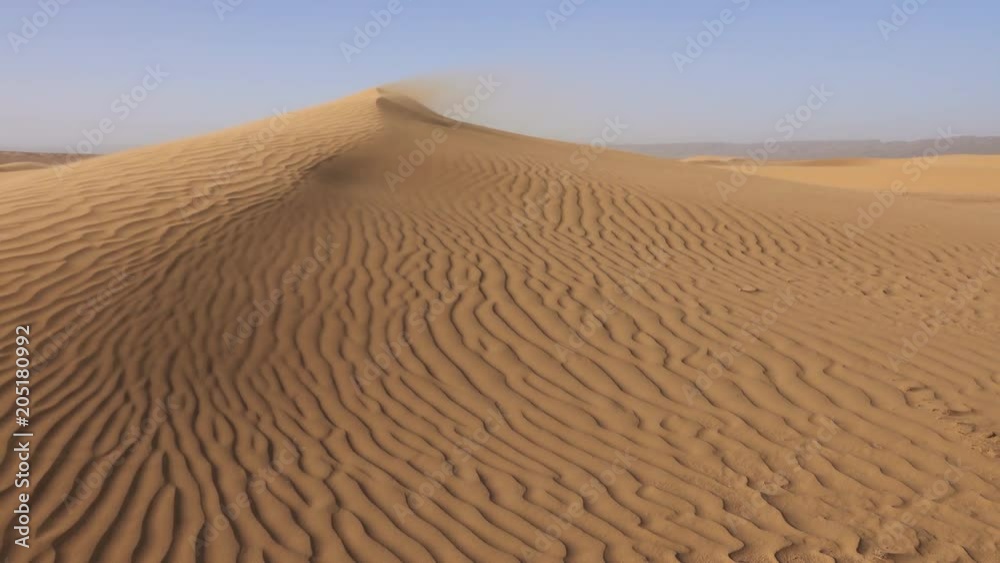 Sand blowing over sand dunes in wind, Sahara desert, 4k