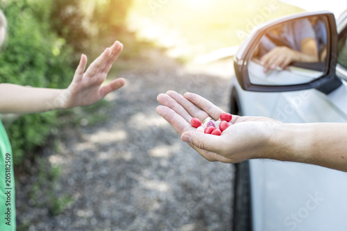 Obraz na płótnie Girl is approached by a strange man in the car and attracted with candy