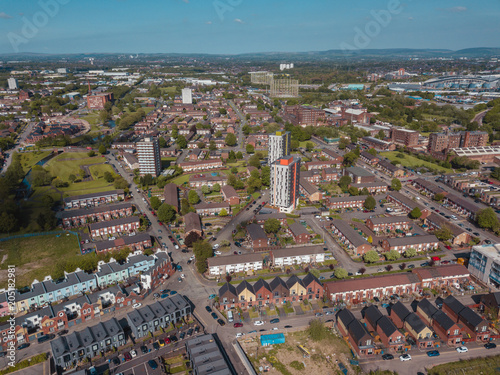 Fototapeta Naklejka Na Ścianę i Meble -  Aerial city centre drone above buildings british manchester skyline summer blue sky ancoats northern quarter