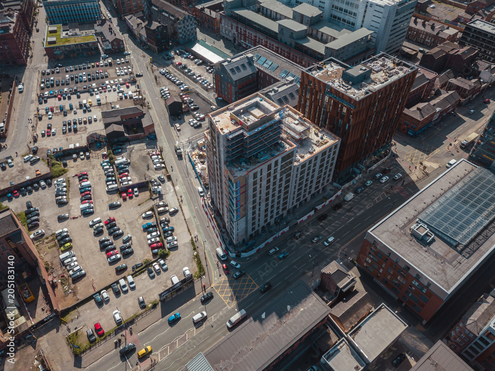 Obraz premium Aerial city centre drone above buildings british manchester skyline summer blue sky ancoats northern quarter