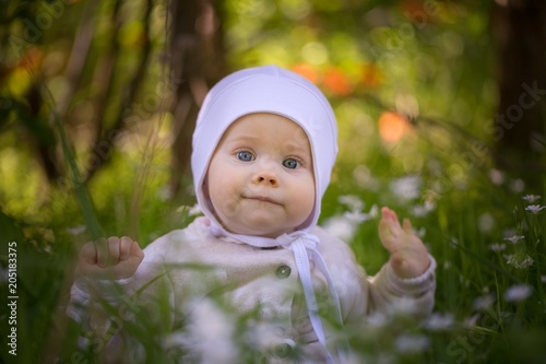 Beautiful infant baby girl portrait  in nature