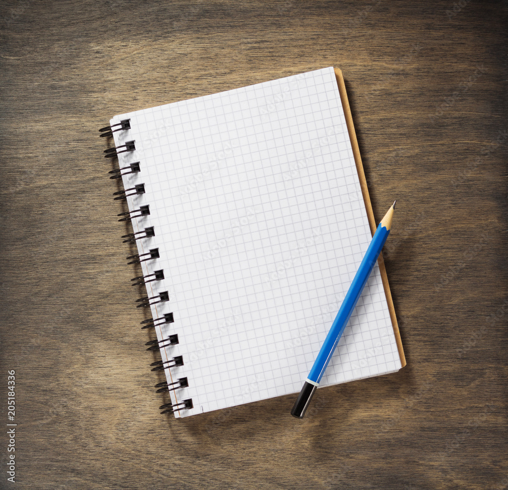 checked notebook and pencil checked notebook and pencil