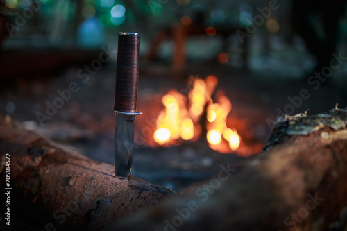 knife in wood by fire photo