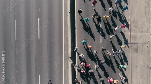 4K Aerial drone fooage. Marathon running on street. Following camera. Top view close up photo