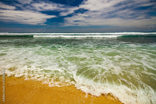 Bali seascape with huge waves at beautiful hidden white sand beach. photo