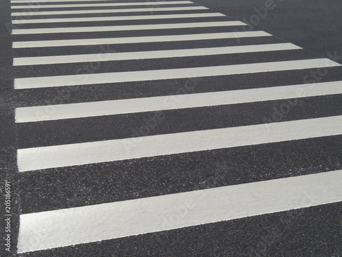 Pedestrian crossing. White zebra lines on asphalt road