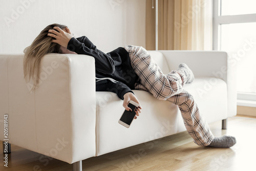 Apathic lazy woman lying in sofa photo