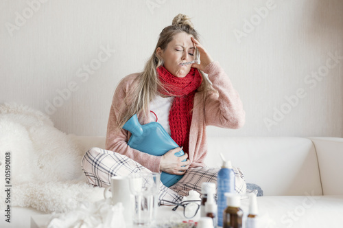 Sick woman measuring temperature photo