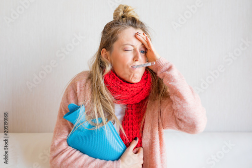 Woman with thermometer in mouth photo