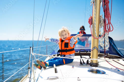 Fototapeta Kids sail on yacht in sea. Child sailing on boat.