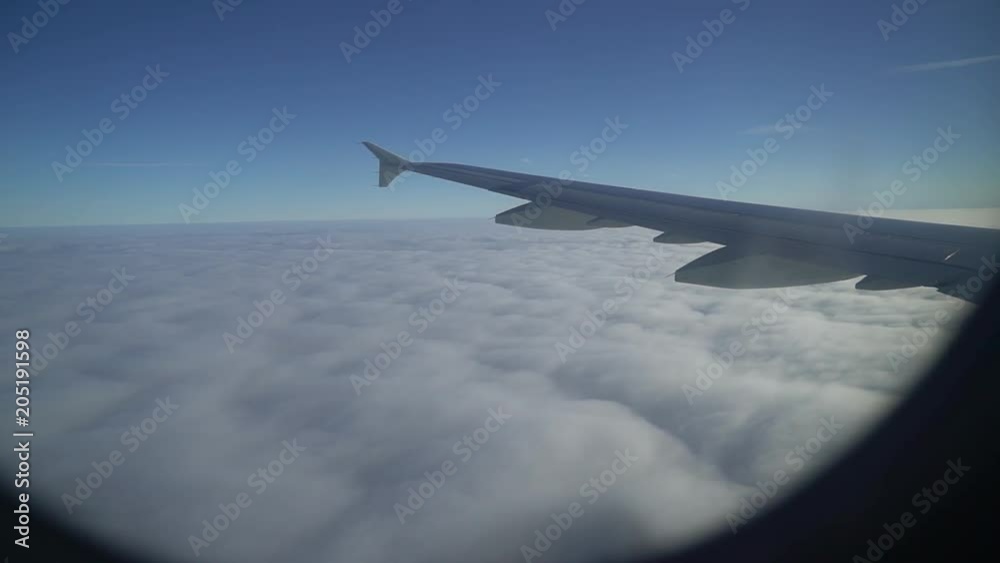 Wing of plane. Airplane window. Wing of airplane from window. Airplane flight. Wing of an airplane flying above the clouds. Aircraft. Traveling by air. Wing of plane. Airplane window. Wing of airplane from window. Airplane flight. Wing of an airplane flying above the clouds. Aircraft. Traveling by air.