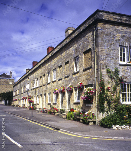 Summer colour on a row of old almshouses, Cecily Hill, Cirencester, Cotswolds, Gloucestershire, UK photo