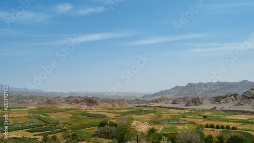 Rural landscape with fields seen from abandoned mud brick village of Kharanaq in Iran