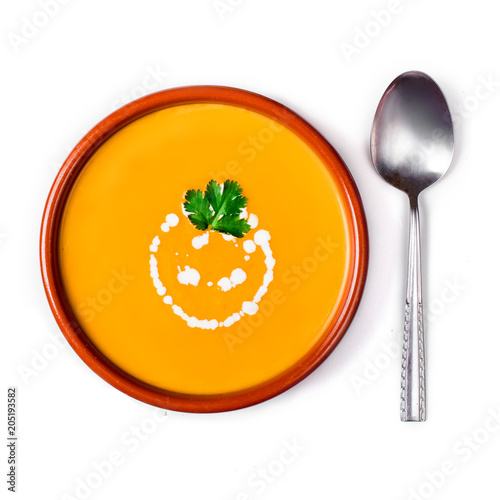 Pumpkin and carrot soup with cream and herbs  isolated on white background.  Flat lay. Dinner concept