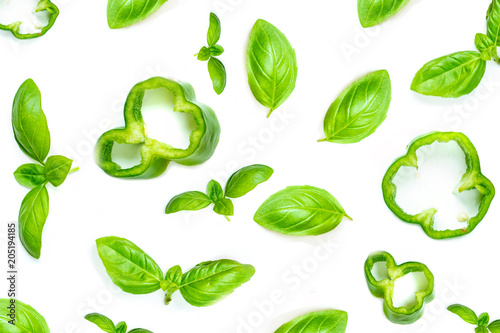 Creative food pattern with Fresh vegetables, herbs and spices isolated on white background. Flat lay. Healthy food background basil leaves, garlic, green pepper. Close up.