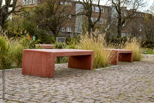 Slika na platnu Concrete benches in red color