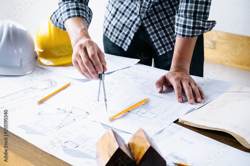 Architect or engineer working in office with blueprints,engineer inspection in workplace for architectural plan,sketching a construction project ,selective focus,Business construction concept.