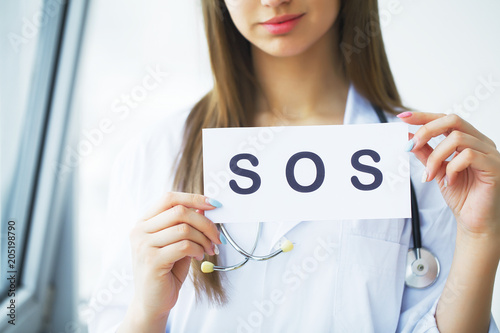 Health Care. Doctor Holding a Card With Symbol HELP, Medical Concept