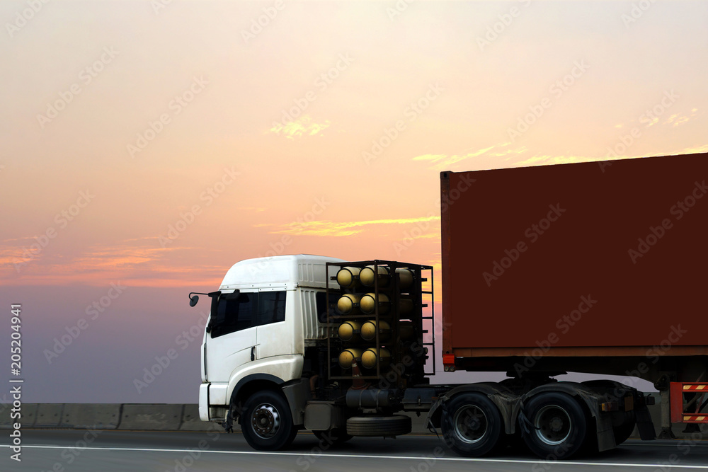 Truck on highway road with red container, transportation concept.,import,export logistic industrial Transporting Land transport on asphalt expressway with sunrise sky