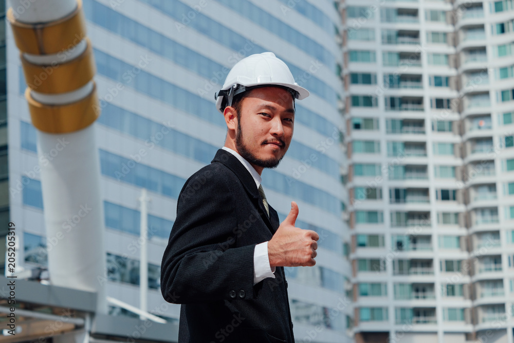 Samrt Engineering standing over buliding site and Showing thumbs up,happy Teamwork concept. Samrt Engineering standing over buliding site and Showing thumbs up,happy Teamwork concept.