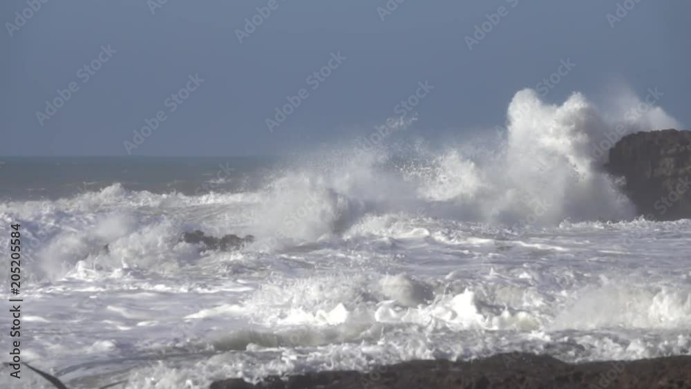 Splashes from atlantic ocean big waves over cliffs, slow motion